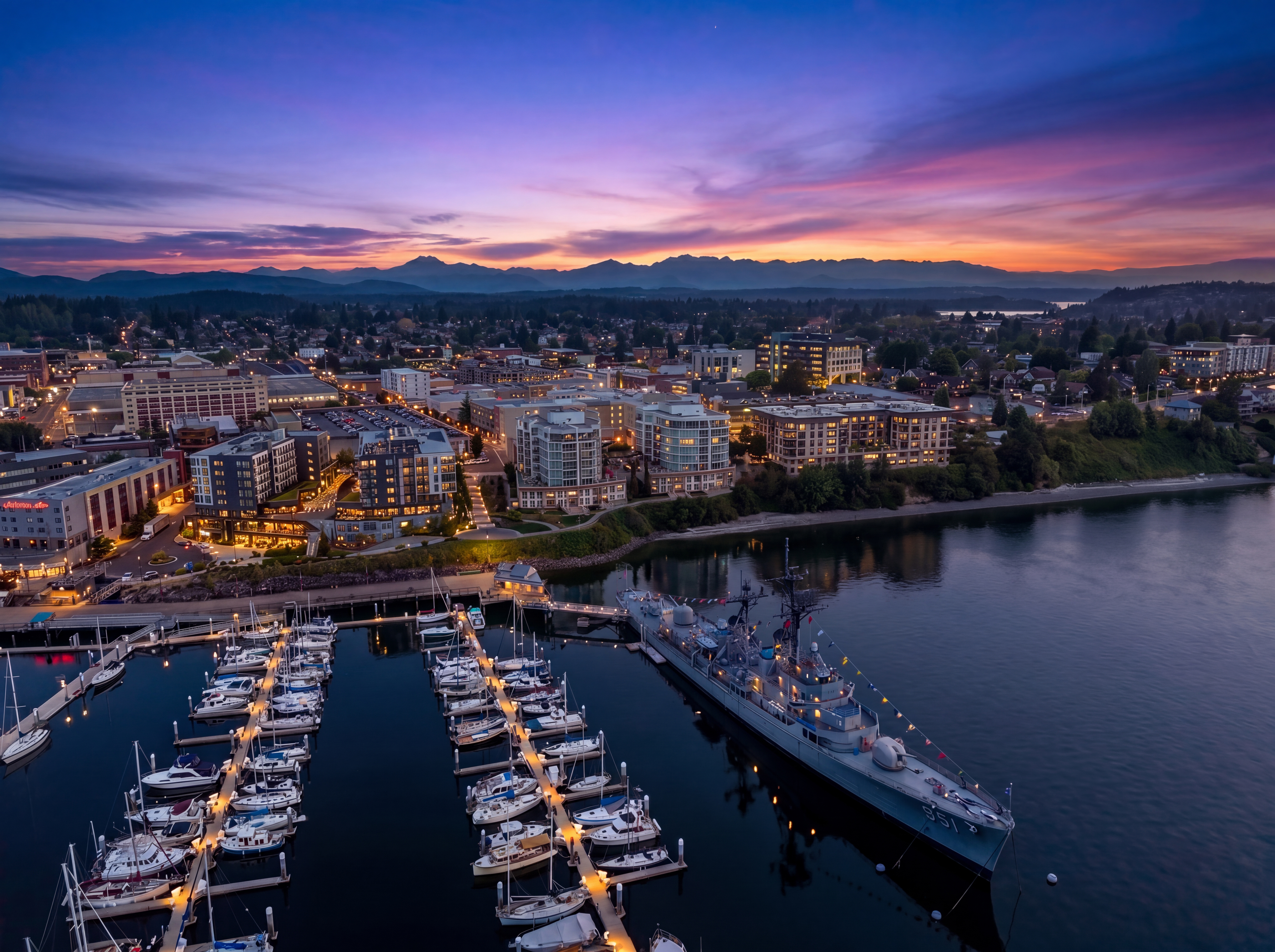 Twilight aerial view of the waterfront city and marina photographed by Memento Imagery